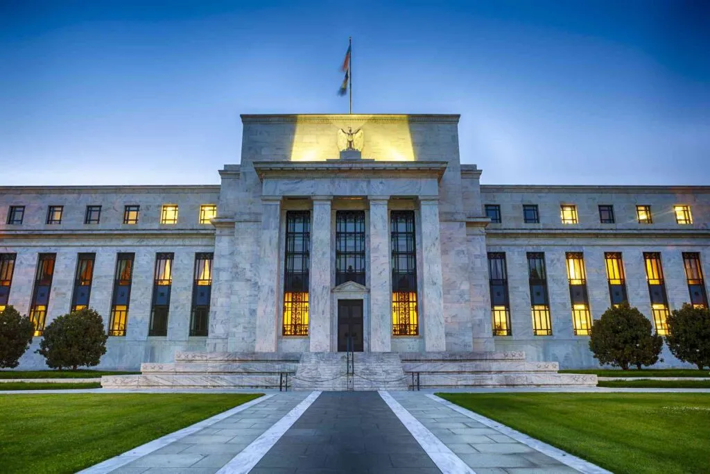 Financial market charts reacting to Federal Reserve meeting minutes and interest rate expectations.